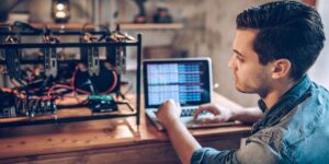 Focused individual configuring a crypto mining rig, highlighting the essential components needed to build a successful setup.