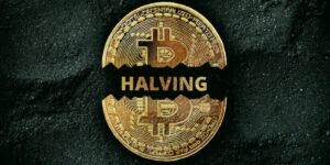 Bitcoin Halving 2024. Bitcoin coin split in half on a dark background with the words 'HALVING' across it, symbolizing the Bitcoin halving event.