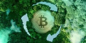 Green Bitcoin mining concept with a silver Bitcoin coin over a lush forest aerial view forming a digital globe