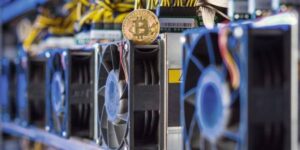 Close-up of ASIC miners with a Bitcoin coin on top.