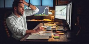 Stressed cryptocurrency trader reacting to volatile market changes while analyzing charts on multiple monitors.