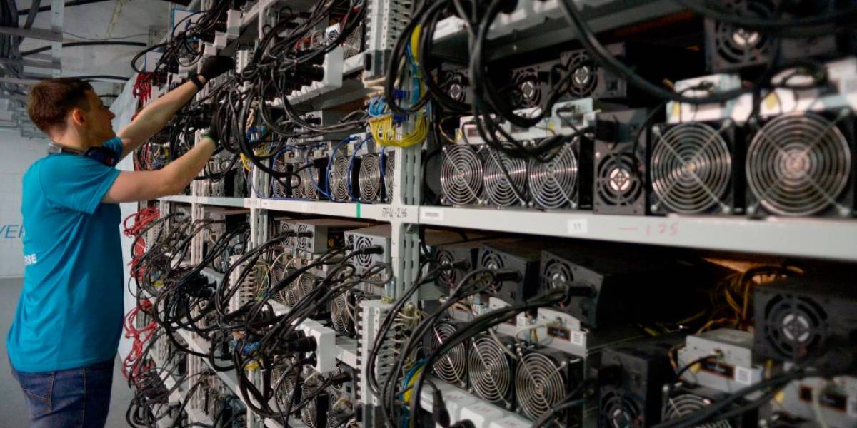 Man fixing bitcoin miner