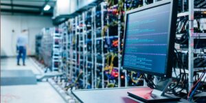 Computer monitor displaying mining software in a cryptocurrency mining facility.
