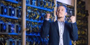 Excited businessman celebrating success inside a cryptocurrency mining facility 