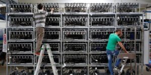 Technicians managing GPU racks for miner hosting in Australia by Mining Store inside a large-scale crypto facility 