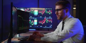 : trader analysing crypto trading profitability on multi-screen setup