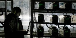 Cryptocurrency mining technician monitoring ASIC miners