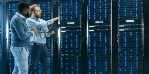 Technicians managing hosted MicroBT Whatsminer units in a secure data center 
