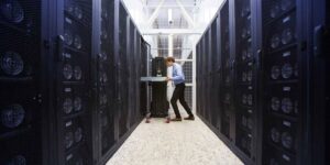 Technician managing hosted mining servers inside a secure data centre facility