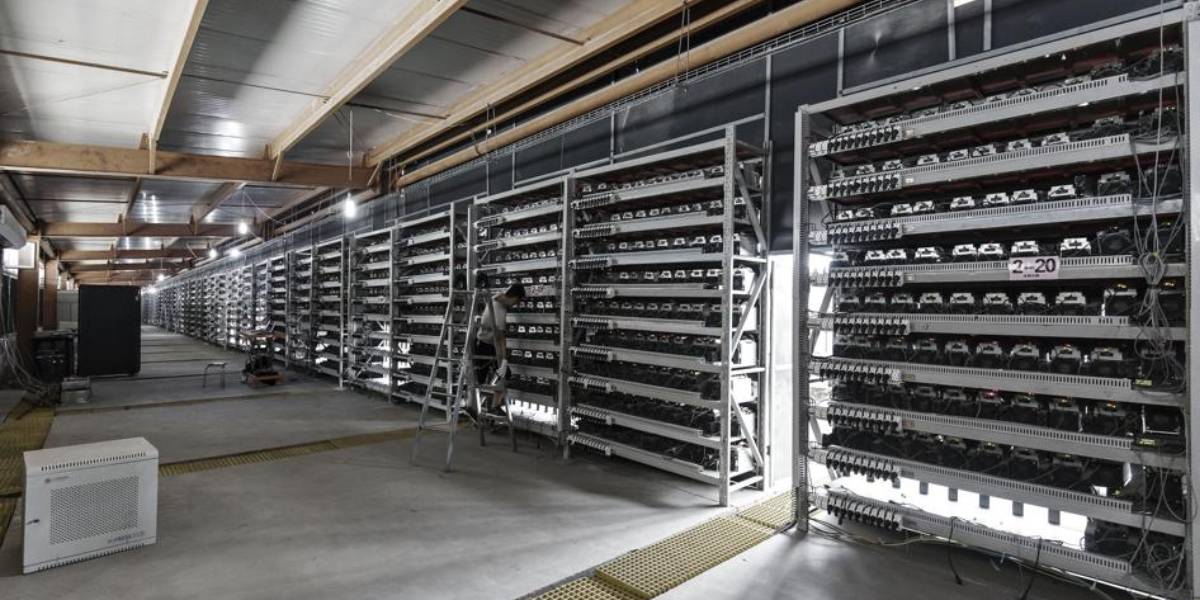 Large cryptocurrency mining farm operating Bitmain miners in industrial racks for Bitcoin mining