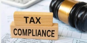 Tax compliance blocks on financial documents beside a judge’s gavel