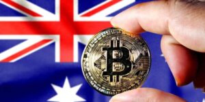 Bitcoin coin held in front of the Australian flag, representing Australia’s crypto regulatory landscape.