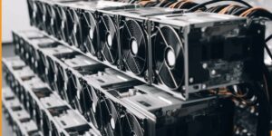 Rows of ASIC miners with cooling fans inside a cryptocurrency mining facility
